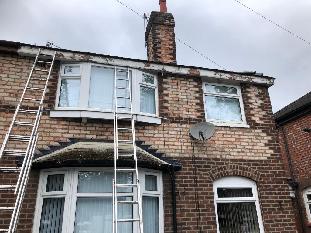 Gutter repair and roofing on brick semi — Before